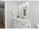 Bathroom with white cabinets, light countertops, modern light fixture and bright white walls at 6393 Laguna Cir, Highlands Ranch, CO 80130