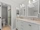 Bright bathroom featuring a double vanity, granite countertops, stylish mirrors and glass shower at 6393 Laguna Cir, Highlands Ranch, CO 80130