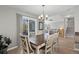 Dining room featuring wood flooring, a chandelier, and a sliding door to the outdoor space at 6393 Laguna Cir, Highlands Ranch, CO 80130