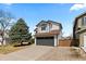 Charming two-story home with a well-manicured lawn and a two-car garage on a sunny day at 6393 Laguna Cir, Highlands Ranch, CO 80130