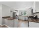 Well-lit kitchen featuring stainless steel appliances, granite countertops and white cabinetry at 6393 Laguna Cir, Highlands Ranch, CO 80130