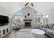 Bright living room with vaulted ceilings, large windows, fireplace and modern furnishings at 6393 Laguna Cir, Highlands Ranch, CO 80130