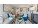 Bright living room with neutral tones, modern furniture, and view into the adjacent kitchen at 2140 Pontiac St, Denver, CO 80207