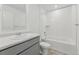 Clean, bright bathroom featuring a shower-tub combo with tile surround and modern vanity at 18708 E 99Th Ave, Commerce City, CO 80022