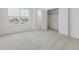 Bedroom features neutral carpet, a window for natural light, and a spacious closet at 18708 E 99Th Ave, Commerce City, CO 80022