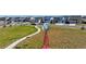 Scenic community park featuring a red windmill statue, walking paths, and new home construction at 18708 E 99Th Ave, Commerce City, CO 80022
