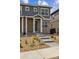 Close up of the front door to the two story home with stone accents, sidewalk and landscaped front yard at 18708 E 99Th Ave, Commerce City, CO 80022