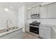 Kitchen featuring granite counters, stainless appliances, and gray cabinets at 18708 E 99Th Ave, Commerce City, CO 80022