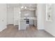 Modern kitchen with gray cabinetry, granite countertops, stainless steel appliances, and eat-in island at 18708 E 99Th Ave, Commerce City, CO 80022