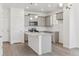 Bright kitchen features gray cabinets, stainless appliances, and center island at 18708 E 99Th Ave, Commerce City, CO 80022