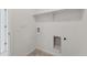 Clean laundry room featuring neutral flooring, shelf, and utility hookups at 18708 E 99Th Ave, Commerce City, CO 80022
