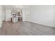 Bright open concept living space featuring modern gray flooring and a view to the contemporary kitchen at 18708 E 99Th Ave, Commerce City, CO 80022