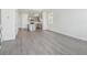 Open floor plan with gray flooring connecting the kitchen and living area for modern living at 18708 E 99Th Ave, Commerce City, CO 80022