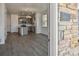 Light-filled open concept living space with modern gray flooring and an open view into the kitchen at 18708 E 99Th Ave, Commerce City, CO 80022