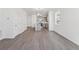 Spacious open concept living area with stylish gray floors and a clear view into the modern kitchen at 18708 E 99Th Ave, Commerce City, CO 80022