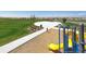 Community park featuring a playground, picnic shelter and seating with lush green grass at 18708 E 99Th Ave, Commerce City, CO 80022