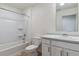 A clean bathroom featuring a shower and tub combo and a single sink at 1923 Westport Ave, Berthoud, CO 80513
