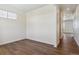 Bright bedroom with a light-filled window and stylish, dark wood-look flooring at 1923 Westport Ave, Berthoud, CO 80513