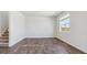 Bright bedroom with a window and sleek, modern, dark wood-look flooring at 1923 Westport Ave, Berthoud, CO 80513