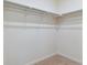 Walk-in closet with metal rods for ample storage and organization at 1923 Westport Ave, Berthoud, CO 80513