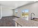 Open kitchen with granite countertops, stainless appliances, and a view to the patio at 1923 Westport Ave, Berthoud, CO 80513