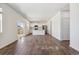 Open-concept kitchen with sleek, light granite counters, stainless appliances, and modern wood flooring at 1923 Westport Ave, Berthoud, CO 80513