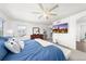 A bright bedroom boasts a ceiling fan, TV, and plenty of natural light at 2153 Mountain Iris Dr, Erie, CO 80516