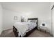 Bedroom with a queen bed with storage and a bedside table, offering comfort and functionality at 2153 Mountain Iris Dr, Erie, CO 80516