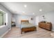 Finished basement bedroom featuring wood frame bed, natural light, walk in closet and mid-century modern dresser at 2153 Mountain Iris Dr, Erie, CO 80516