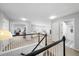 Upstairs hallway boasts plush carpets, and white doors that enhance the overall brightness of the home at 2153 Mountain Iris Dr, Erie, CO 80516