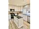 Bright kitchen features an island, stainless appliances, and a view to the backyard at 2153 Mountain Iris Dr, Erie, CO 80516