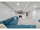 Finished living room with plush blue sectional, fireplace, and built-in shelving, ideal for relaxing and entertaining at 2153 Mountain Iris Dr, Erie, CO 80516