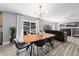 Open concept living room and dining room with sliding doors to backyard and fireplace at 2153 Mountain Iris Dr, Erie, CO 80516