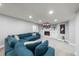 Spacious living room offering a large blue sectional, built-in shelves, and a cozy fireplace feature at 2153 Mountain Iris Dr, Erie, CO 80516