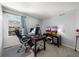 A home office features a desk, TV setup, and a comfortable workspace for productivity at 2153 Mountain Iris Dr, Erie, CO 80516