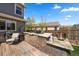 Custom outdoor kitchen with stone surround, stainless steel grill, and ample counter space on the wooden deck at 2153 Mountain Iris Dr, Erie, CO 80516
