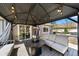 Charming covered patio featuring comfortable seating, a fire pit, and a built-in grill for outdoor entertaining at 2153 Mountain Iris Dr, Erie, CO 80516