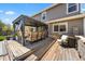 Expansive wooden patio with an outdoor lounge area, built-in grill, and ample seating for enjoying outdoor living at 2153 Mountain Iris Dr, Erie, CO 80516