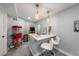 Well-lit recreation room featuring wet bar, white bar stools, Pac-Personal arcade, and a popcorn machine at 2153 Mountain Iris Dr, Erie, CO 80516