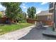 Outdoor patio area in a backyard setting, featuring a dining set and ample green space at 2261 Alpine Dr, Erie, CO 80516