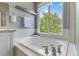 Bathroom features a large soaking tub with a view of the backyard trees at 2261 Alpine Dr, Erie, CO 80516