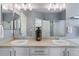 Modern bathroom boasts dual sinks, a large mirror, and updated fixtures at 2261 Alpine Dr, Erie, CO 80516