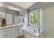 Light and airy bathroom features a soaking tub, shower, and vanity at 2261 Alpine Dr, Erie, CO 80516