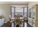Elegant dining room featuring a chandelier, large windows, and refined furniture at 2261 Alpine Dr, Erie, CO 80516