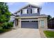 Stylish two-story home featuring a two-car garage, brick accents, and a beautifully maintained front yard at 2261 Alpine Dr, Erie, CO 80516