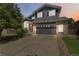 Beautiful two-story house with a spacious driveway, brick and gray siding, and manicured landscaping at 2261 Alpine Dr, Erie, CO 80516