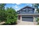 Inviting home with a well-maintained lawn, mature trees, and a two-car garage for convenience and curb appeal at 2261 Alpine Dr, Erie, CO 80516