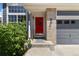 Inviting front porch with a bright red door, brick accents, and well-maintained landscaping at 2261 Alpine Dr, Erie, CO 80516