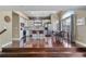 Open floor plan showcases kitchen with white cabinets, stainless appliances, dining area and hardwood floors at 2261 Alpine Dr, Erie, CO 80516
