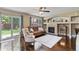 Warm living room with fireplace, comfortable seating, sliding glass door to backyard, and hardwood floors at 2261 Alpine Dr, Erie, CO 80516
